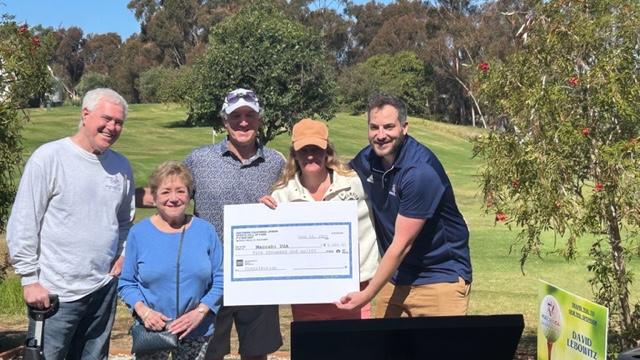 SCJSHOF representatives present a five thousand dollar ceremonial check to Maccabi USA on a golf course